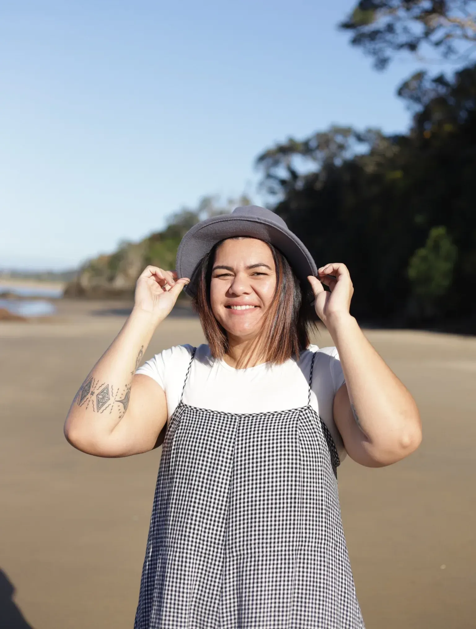 Lian Passmore smiling at the camera on the beach
