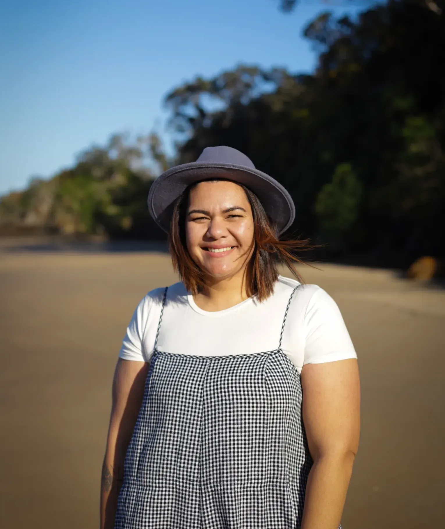 Lian Passmore smiling at the camera on the beach