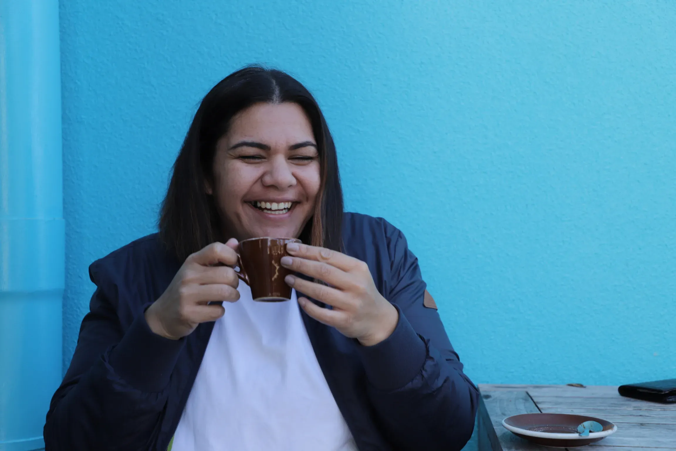 Lian Passmore laughing over a coffee